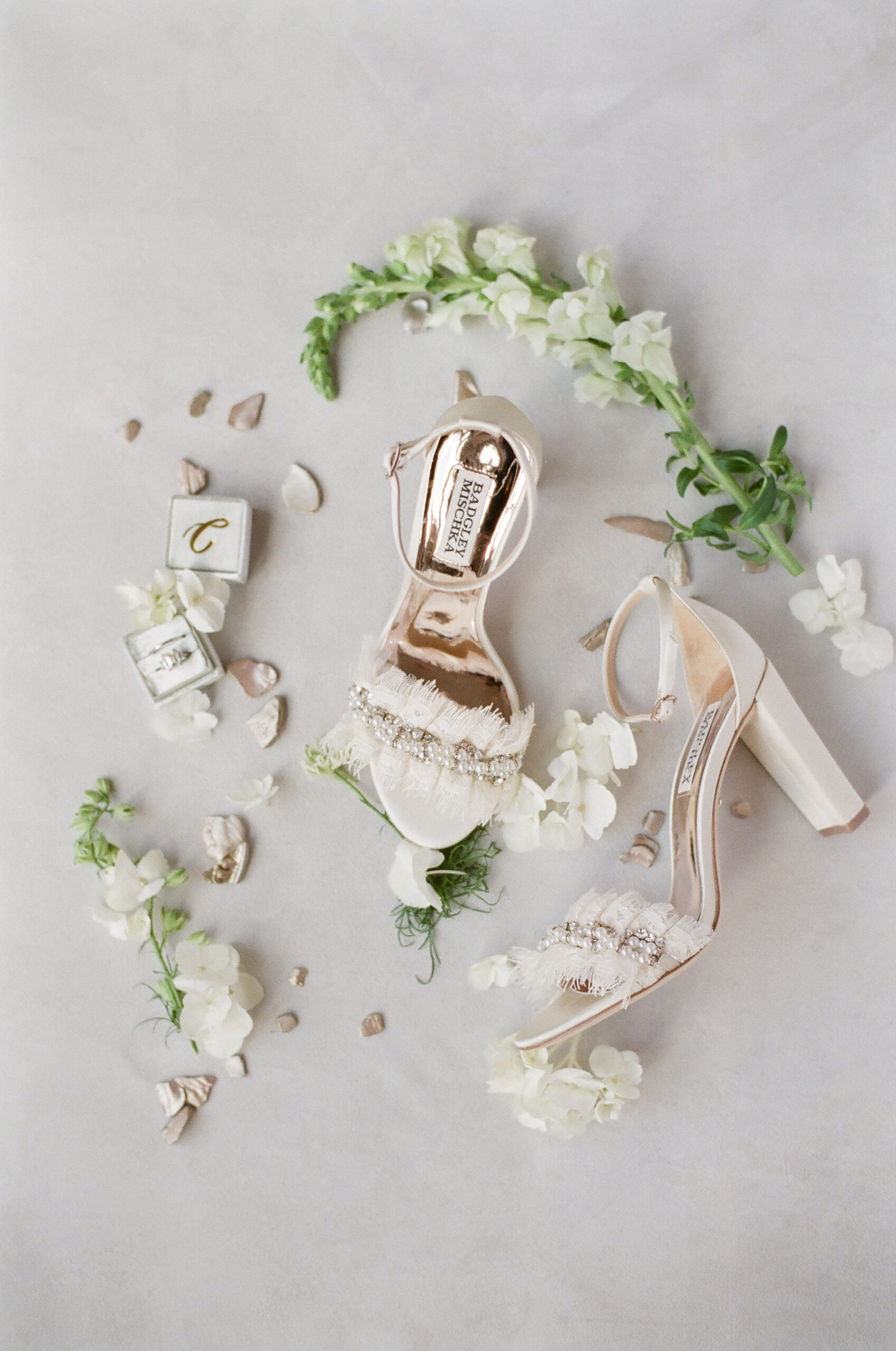 planning-a-destination-wedding-in-new-england wedding details of brides shoes, ring, and florals while planning a destination wedding in New England