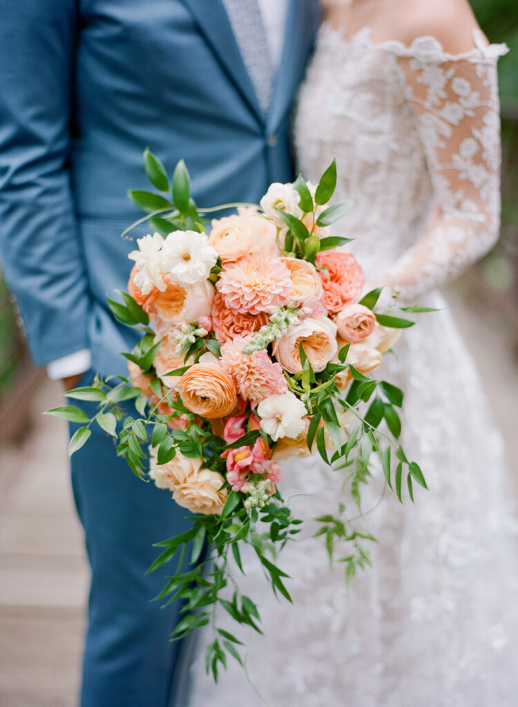 planning-a-destination-wedding-in-new-england bride and groom with a stunning peach toned bouquet while planning a destination wedding in New England