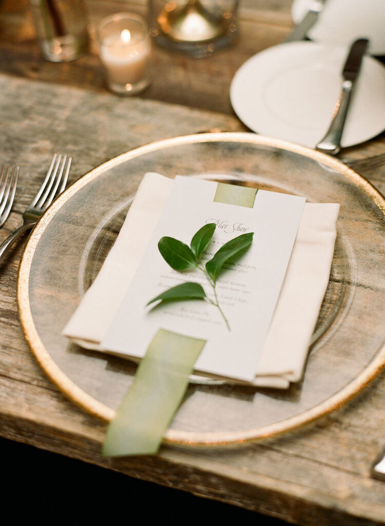 planning-a-destination-wedding-in-new-england wedding reception details of the dinner menu with a leaf decoratively placed on top