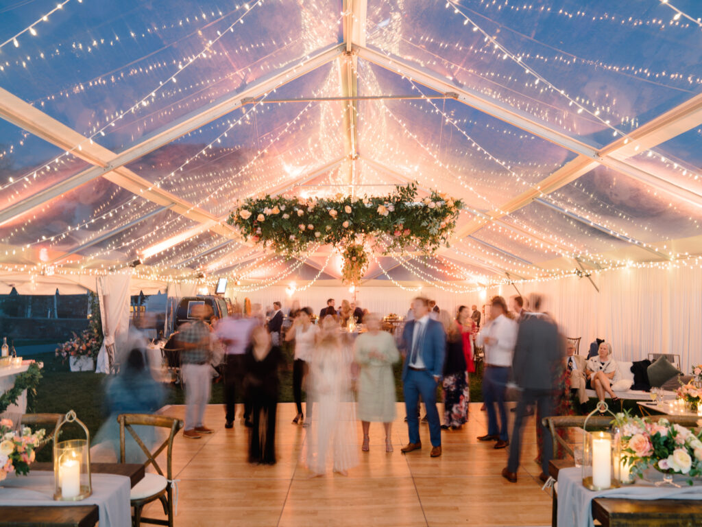 tented-wedding Magical wedding reception with string lights and dancing guests.