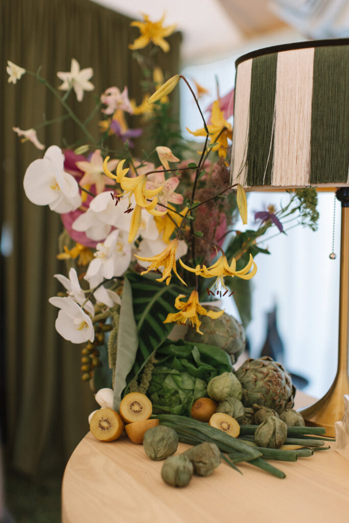 Organic wedding colors for a fall wedding featuring artichokes, orchids, golden kiwi, and lush greenery.