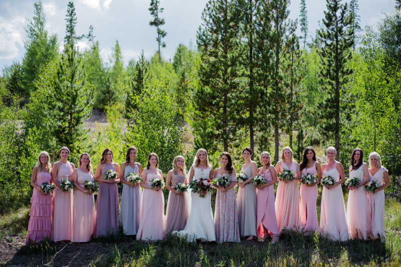 2026 wedding design trend with mismatched blush bridesmaid dresses styled for an outdoor mountain celebration.