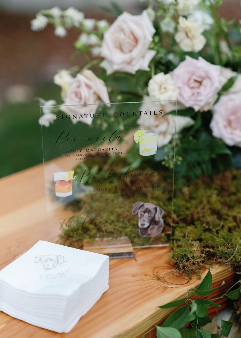 Acrylic signature cocktail sign with pet illustration and moss accents for personalized wedding design ideas.