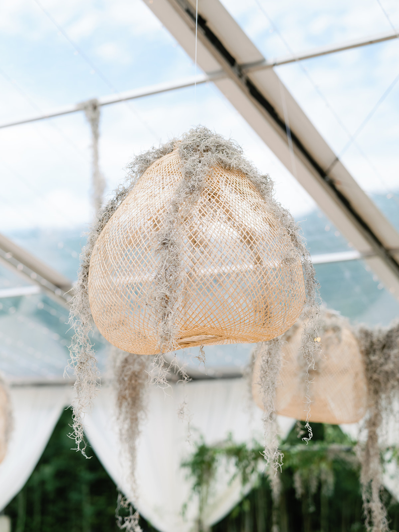 Woven pendant light with hanging moss, adding texture and ambiance to unique wedding design ideas.