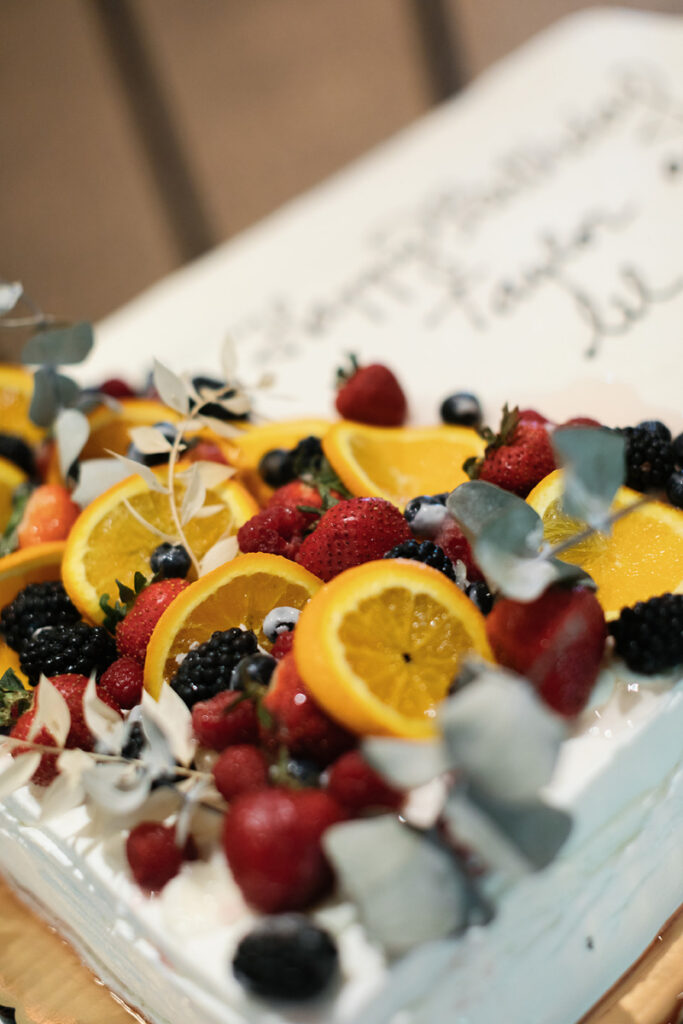 Fresh citrus and berry display with strawberries and oranges at Cape Cod wedding venue reception table.