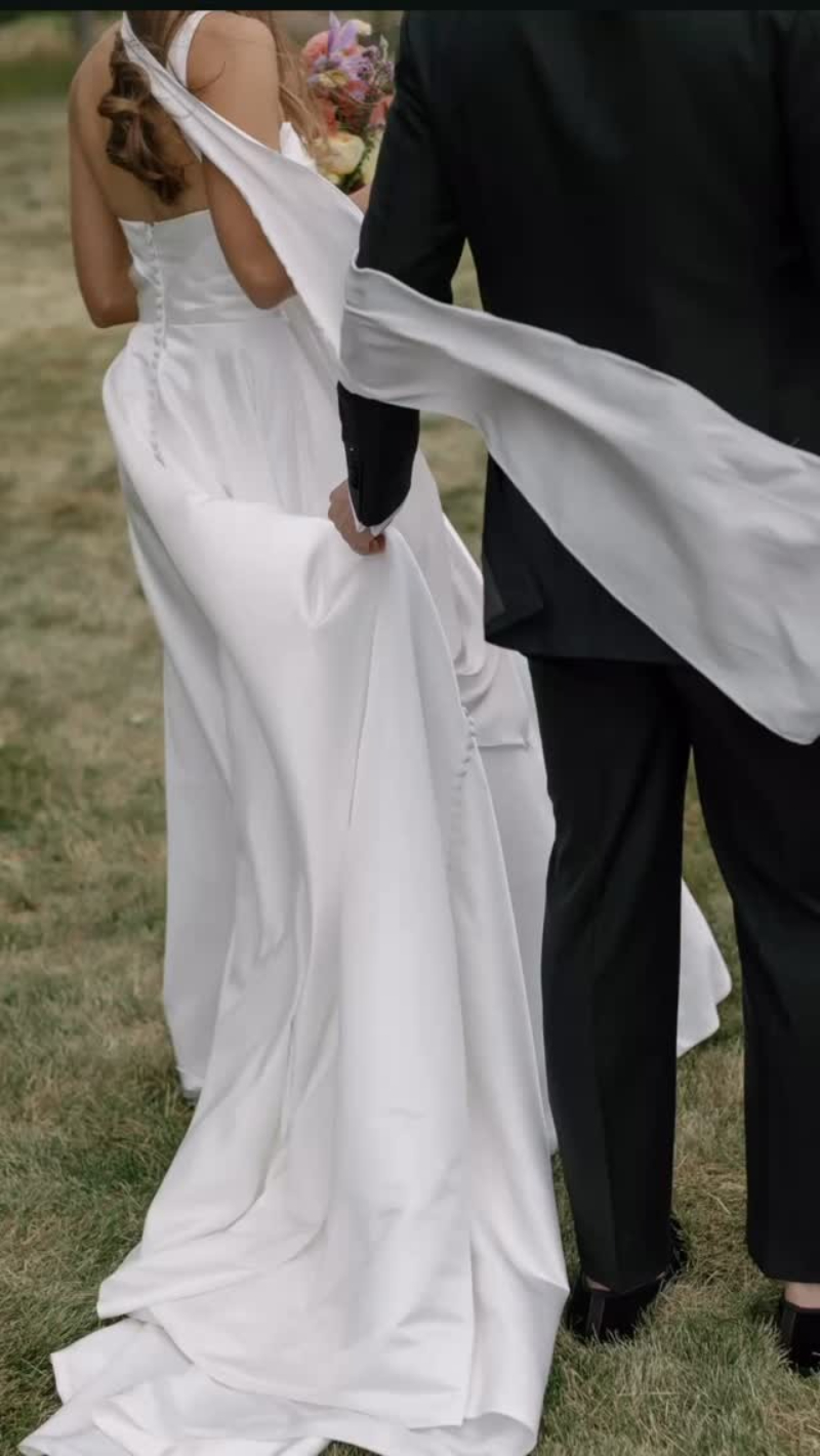 Bride and groom walking outdoors at estate celebration planned through full-service wedding planning.