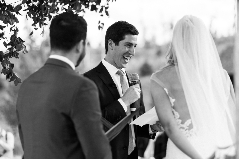 Groom smiling during vows at ceremony, joyful moment captured at Boston’s spring wedding venues outdoors