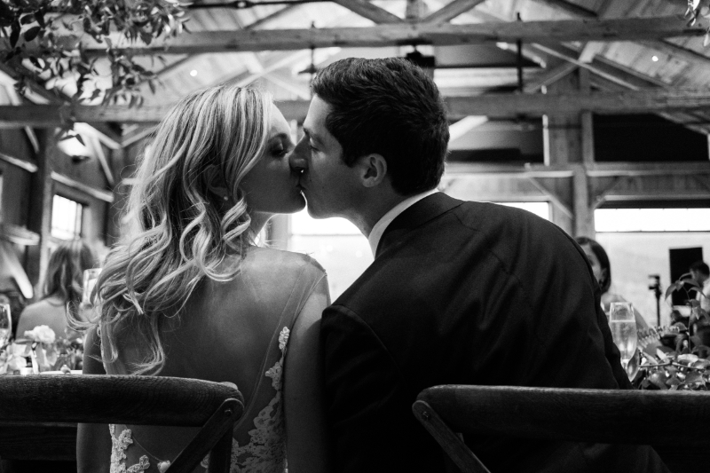 Romantic couple sharing a kiss, timeless moment captured at one of Boston’s spring wedding venues