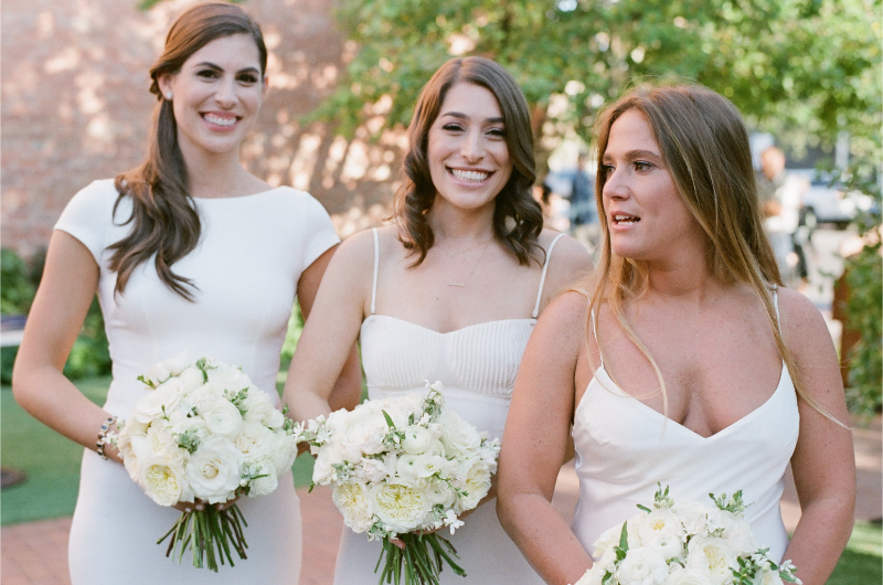 Bridal party in white dresses with bouquets, outdoor Boston wedding style inspired by wedding trends 2026